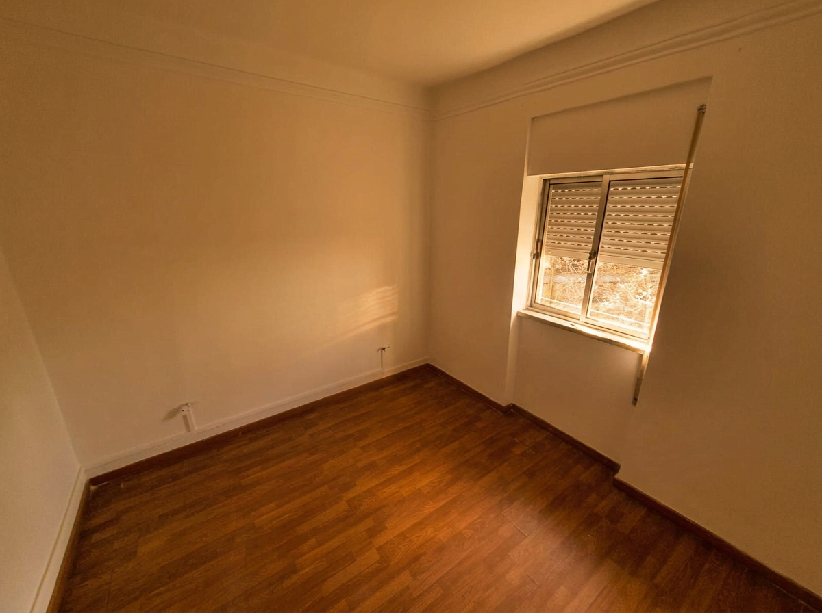 Bedroom with wooden floors bathed in late-afternoon sun